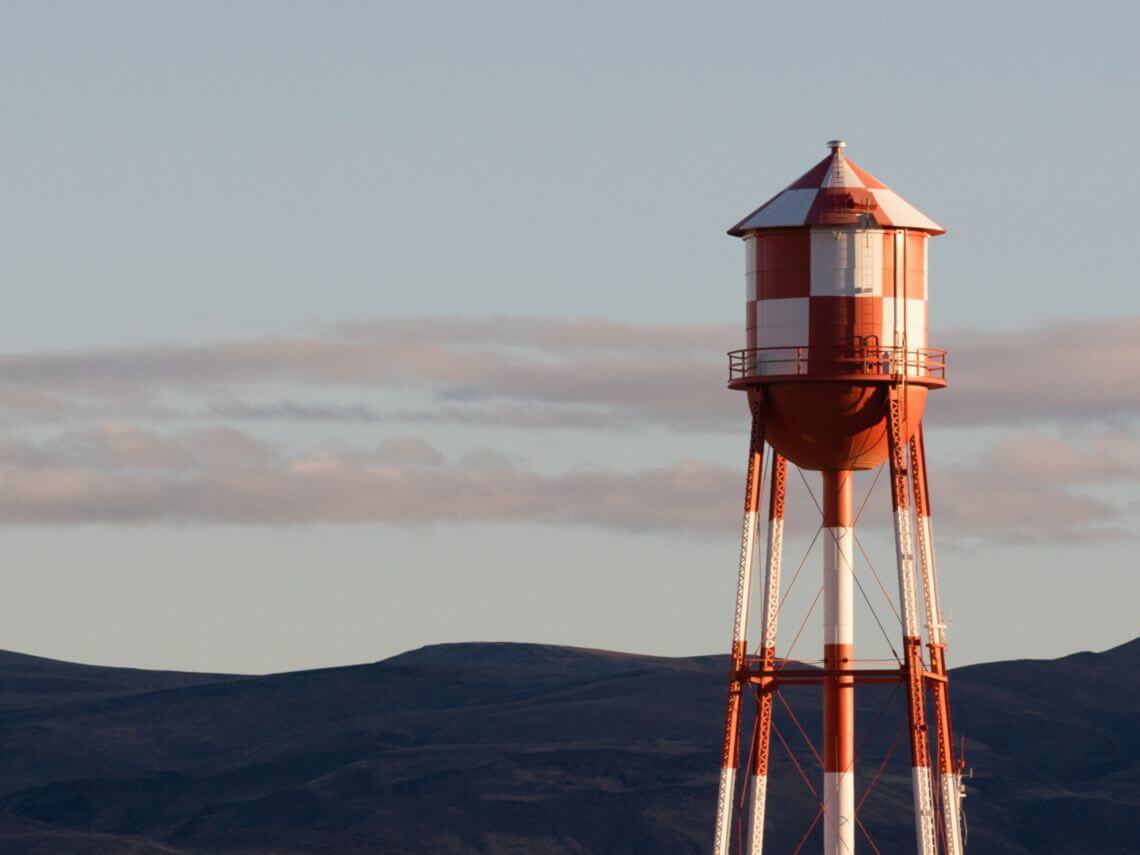 A red and white checkered water tower containing water resources for native american tribes