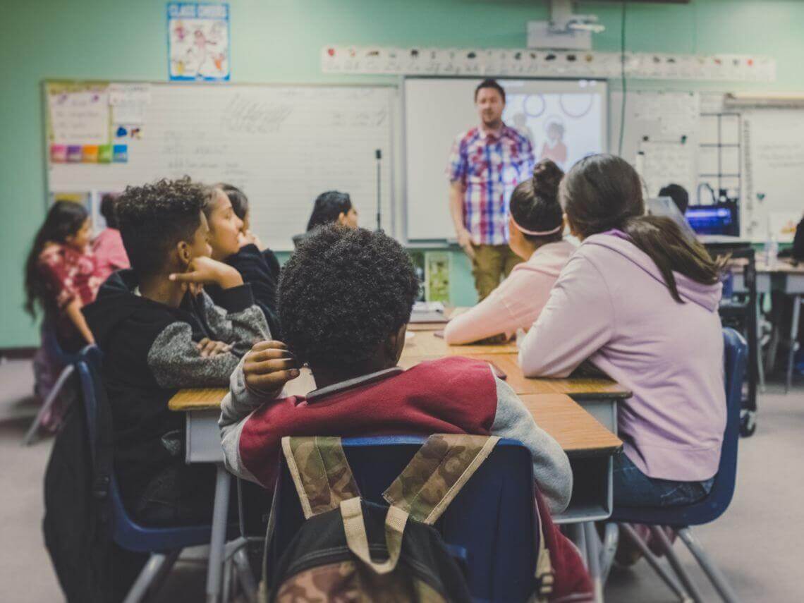 A classroom full of students and a teacher school funding