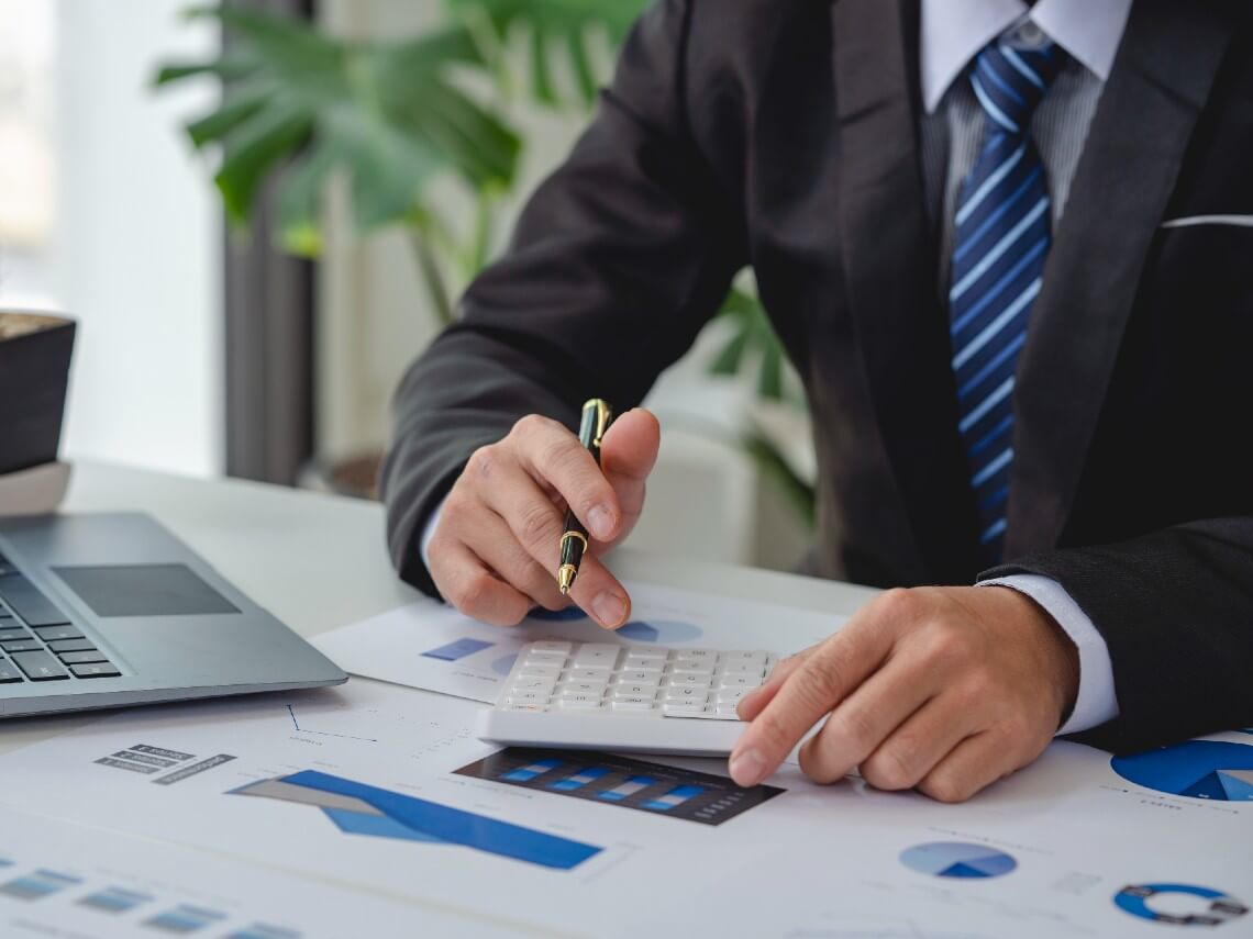 Closeup of accountant working with a calculator