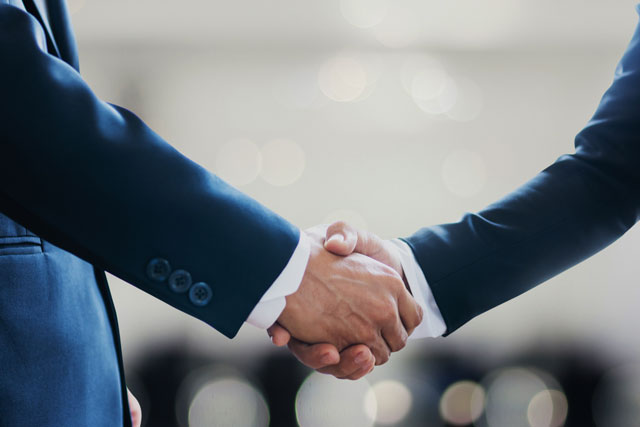 close-up of two lawyers shaking hands